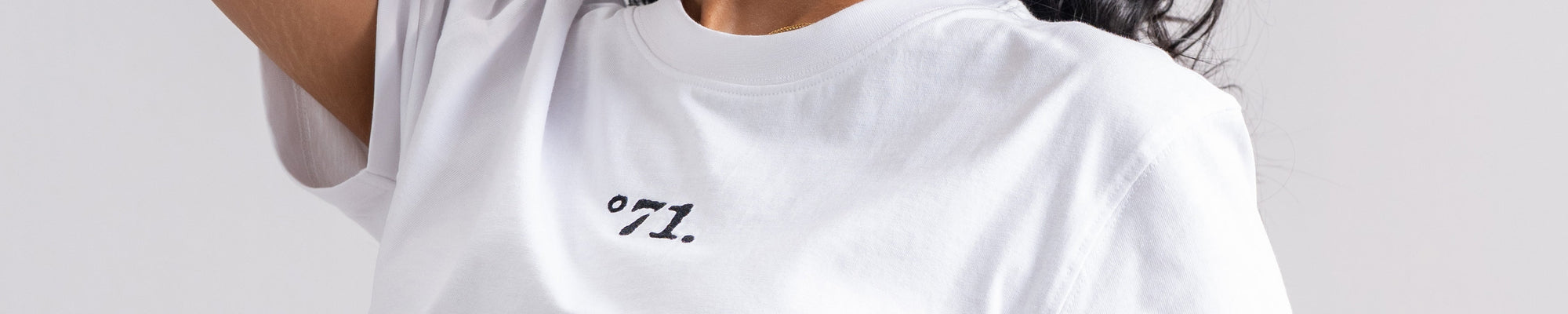 A close-up of draped white fabric with soft folds and shadows.